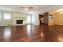 Bright living room featuring hardwood floors, a fireplace, and an open layout connecting to the kitchen and dining area at 5243 Valleyview Dr, Acworth, GA 30102