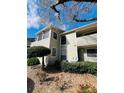 Well-kept condo exterior with tidy landscaping and a private covered deck at 3432 Ivys Walk, Atlanta, GA 30340