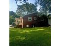 Brick home with a covered side porch and a well-kept lawn, perfect for enjoying the outdoors at 3629 Centerview Dr, Marietta, GA 30066