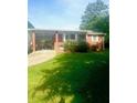 Cozy brick home featuring a covered carport and well-maintained lawn in a peaceful neighborhood setting at 3629 Centerview Dr, Marietta, GA 30066