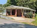 Charming single-story brick home with a covered porch, driveway, and well-maintained landscaping at 3629 Centerview Dr, Marietta, GA 30066