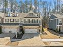 Charming two-story townhome showcasing a brick driveway and meticulously maintained front yard at 495 Duval Dr, Alpharetta, GA 30009