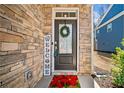 Welcoming front door with stone accents, wreath, and cheerful welcome sign at 495 Duval Dr, Alpharetta, GA 30009