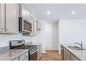 Stylish kitchen showcasing stainless steel appliances, granite countertops, and ample storage space in modern cabinetry at 6123 Knickerbocker St, Mableton, GA 30127