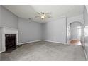 Spacious living room with fireplace, ceiling fan, and neutral decor for comfortable living at 1332 Adcox Sq, Stone Mountain, GA 30088