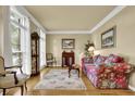 Cozy living room with hardwood floors, floral sofa, and large window with sheer curtains at 283 Heron Lake Ct, Lawrenceville, GA 30043