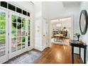 Bright foyer featuring hardwood floors, glass panel door, and an open view to the dining room at 4411 Paces Battle Nw, Atlanta, GA 30327