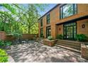 Charming brick home with a brick patio, green foliage and many entrances into the home at 4411 Paces Battle Nw, Atlanta, GA 30327