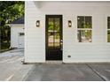 Close-up of the home's front door and covered porch, complete with stylish light fixtures and detailed trim at 1888 Goddard Se St, Atlanta, GA 30315