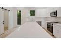 Bright kitchen with a large island, stainless steel appliances, and white cabinetry and countertops at 1888 Goddard Se St, Atlanta, GA 30315