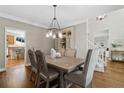 Elegant dining room with hardwood floors and stylish light fixture at 235 Foxley Way, Roswell, GA 30075