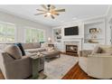Cozy living room with fireplace, built-in shelves, and large sectional sofa at 235 Foxley Way, Roswell, GA 30075