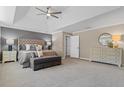 Spacious main bedroom features a tray ceiling, carpet, and seating area at 235 Foxley Way, Roswell, GA 30075