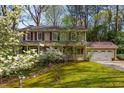 Beautiful two-story home featuring an attached two car garage and landscaped front yard at 6795 Brandon Mill Rd, Atlanta, GA 30328