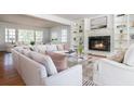 Bright living room with a fireplace, built-in bookshelves, hardwood floors, and large windows at 6795 Brandon Mill Rd, Atlanta, GA 30328