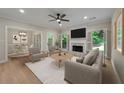 Cozy living room featuring a fireplace, neutral furniture, and hardwood flooring at 8675 Hope Vine, Roswell, GA 30076