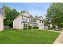 Two-story home showing the side view, featuring a manicured lawn, attached garage, and partial view of the street at 2896 Chilhowee Dr, Atlanta, GA 30331