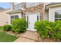 A close-up of the front door with stone accents and green bushes accenting the walkway at 2896 Chilhowee Dr, Atlanta, GA 30331