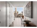 Contemporary hallway with hardwood floors leading to a living area with a piano and city views at 45 Ivan Allen Jr Nw Blvd # 2705, Atlanta, GA 30308
