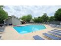 Inviting community pool with plenty of lounge chairs and manicured landscape at 672 Mcgill Ne Pl # 672, Atlanta, GA 30312