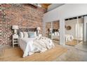 Cozy bedroom with exposed brick, a mirrored closet, and a comfortable rug at 204 Walker Sw St # 319, Atlanta, GA 30313