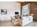 Open living room showcasing exposed brick wall, a large window, and a comfortable seating area at 204 Walker Sw St # 319, Atlanta, GA 30313