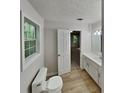 Clean bathroom featuring a single sink vanity, modern fixtures, and a view into bedroom at 26 Nottingham Nw Dr, Cartersville, GA 30121