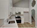 Modern kitchen featuring stainless steel appliances, bright countertops, and white cabinets at 26 Nottingham Nw Dr, Cartersville, GA 30121