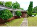 This beautiful home boasts mature landscaping and a brick facade at 3967 Norman Rd, Stone Mountain, GA 30083