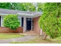 Inviting front entrance with brick facade and well-manicured landscaping at 3967 Norman Rd, Stone Mountain, GA 30083