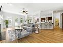 Sun-filled living room with hardwood floors, modern furnishings, open floor plan, and seamless flow into the kitchen at 4011 Charrwood Trce, Marietta, GA 30062