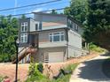 A modern two-story home with wood accents, a private garage, and a walkway to the front door at 4107 Danforth Sw Rd, Atlanta, GA 30331