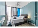 Cozy bedroom featuring a modern bed with stylish headboard and light blue walls at 215 Piedmont Ne Ave # 303, Atlanta, GA 30308