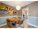 Comfortable dining area with round wooden table and modern lighting fixture and kitchen access at 215 Piedmont Ne Ave # 303, Atlanta, GA 30308