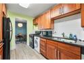A well-maintained kitchen featuring wooden cabinetry and modern appliances, with a dining area visible at 215 Piedmont Ne Ave # 303, Atlanta, GA 30308