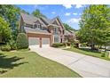 Brick two-story home with a well-manicured lawn, two-car garage and a classic architectural style at 580 Washington Way, Cumming, GA 30040