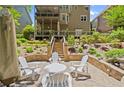 The backyard features a lovely stone patio with comfortable seating and a covered deck above, perfect for entertaining at 580 Washington Way, Cumming, GA 30040