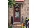 Inviting entrance with a decorative wreath and a well-lit porch at 10765 Arlington Pt, Alpharetta, GA 30022