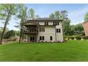 Expansive backyard featuring a covered patio/deck perfect for outdoor entertaining at 3915 Ashley Trace Sw Ct, Lilburn, GA 30047