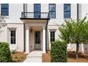 Close up of front door entrance with classic trim, complemented by manicured landscaping at 415 Mayfair Ct, Alpharetta, GA 30009