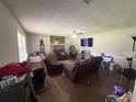 Cozy living room with a stone fireplace, ceiling fan, and comfortable leather recliners at 4284 Village Green W Cir, Conyers, GA 30013