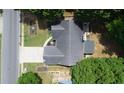 Birds eye view of a home with a manicured lawn and mature tree coverage surrounding the property at 5742 Riverside Walk Dr, Sugar Hill, GA 30518