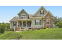 Charming two-story home boasting complementary siding, stone accents and a welcoming front porch at 46 Grand Georgian Ne Ct, Cartersville, GA 30121