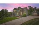 Inviting two-story home featuring stone accents, complementary siding and a detached garage at 46 Grand Georgian Ne Ct, Cartersville, GA 30121