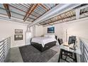 Cozy loft bedroom featuring a bed, desk, and stylish decor under an industrial-style ceiling at 572 Edgewood Se Ave # 303, Atlanta, GA 30312