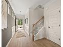 Inviting foyer with hardwood floors, elegant wainscoting, and a staircase leading to the upper level at 106 Jacobs Farm Ln # 42, Lawrenceville, GA 30045