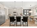 Stylish kitchen with stainless steel appliances, granite countertops, central island with seating, and adjacent dining area at 106 Jacobs Farm Ln # 42, Lawrenceville, GA 30045