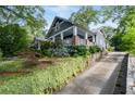 A charming two-story home is nestled on a beautifully landscaped lot with a stone driveway at 1228 Hosea L Williams Ne Dr, Atlanta, GA 30317