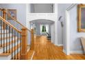 Inviting foyer showcasing hardwood floors, staircase, and elegant architectural details at 1614 Rucker Rd, Alpharetta, GA 30009