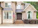 Close-up view of the front entrance, highlighting brickwork and double doors at 1614 Rucker Rd, Alpharetta, GA 30009
